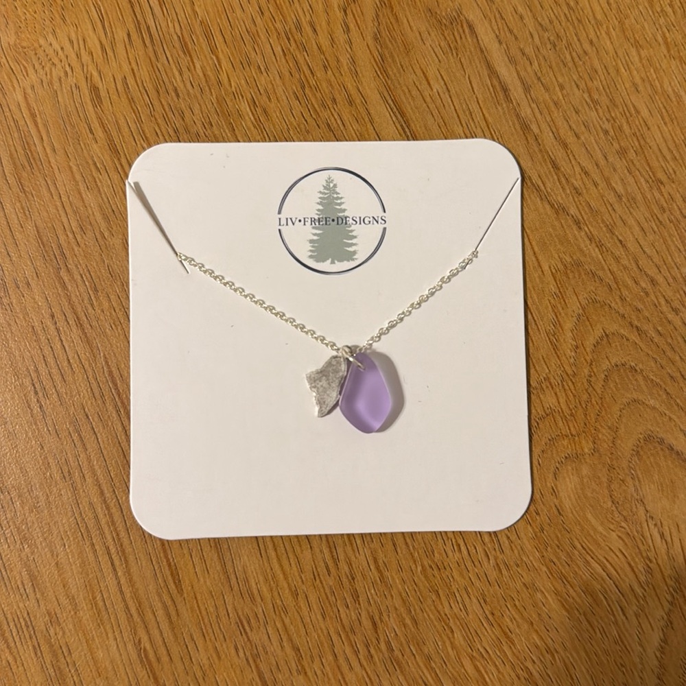 Silver necklace with purple pendant and state of Maine shape
